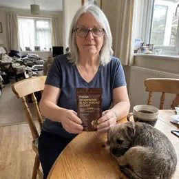 Joan P. with her PURAVA pouch and her dog